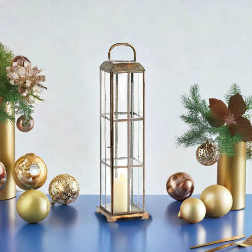 Brass and glass lantern with antique finish displayed on console table with festive accents and greenery – Modern Farmhouse