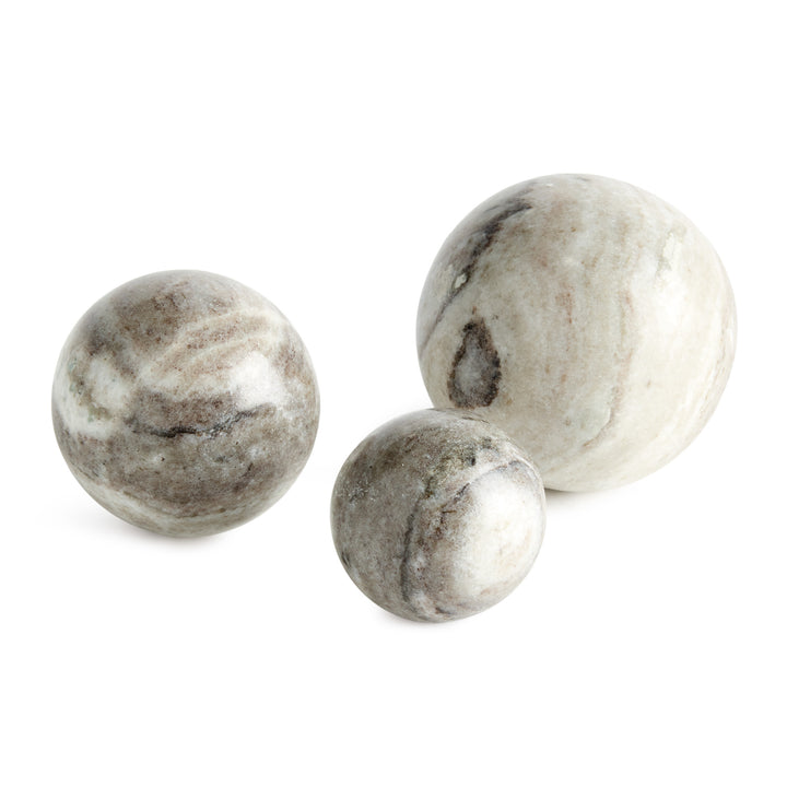 Three brown and white marble orbs in graduated sizes, showing broad natural veining and softly honed surfaces. Modern Organic