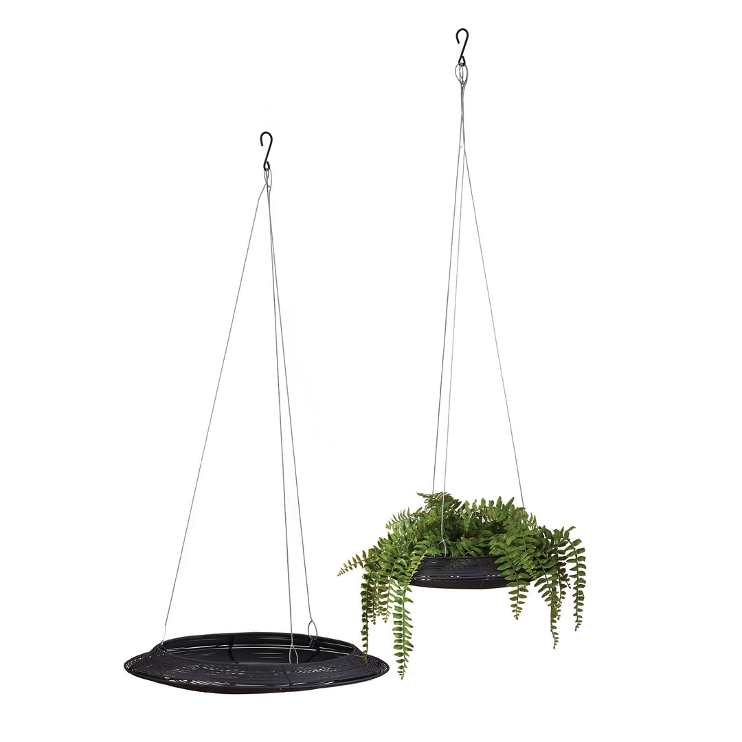 Two black iron hanging baskets with shallow circular trays and suspension wires, one styled with greenery, in Modern style