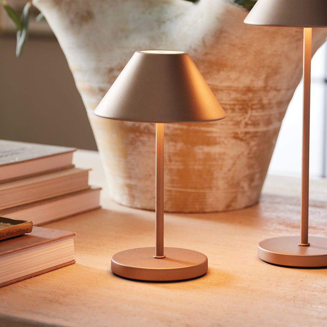 Bronze cordless LED table lamp with metal empire shade styled on a tabletop beside books and decorative accents – Contemporary