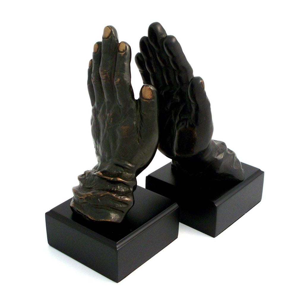 Pair of sculptural bronze hands bookends with black wood bases, 10 inch height, shown angled together as decorative and functional accents – Transitional Classic.