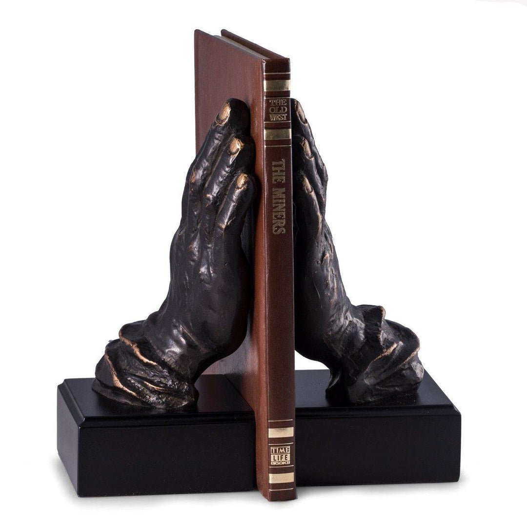 Cast metal bronze hands bookends on black wood base, 10 inches tall, supporting hardcover book upright for library or home office display – Transitional Classic.