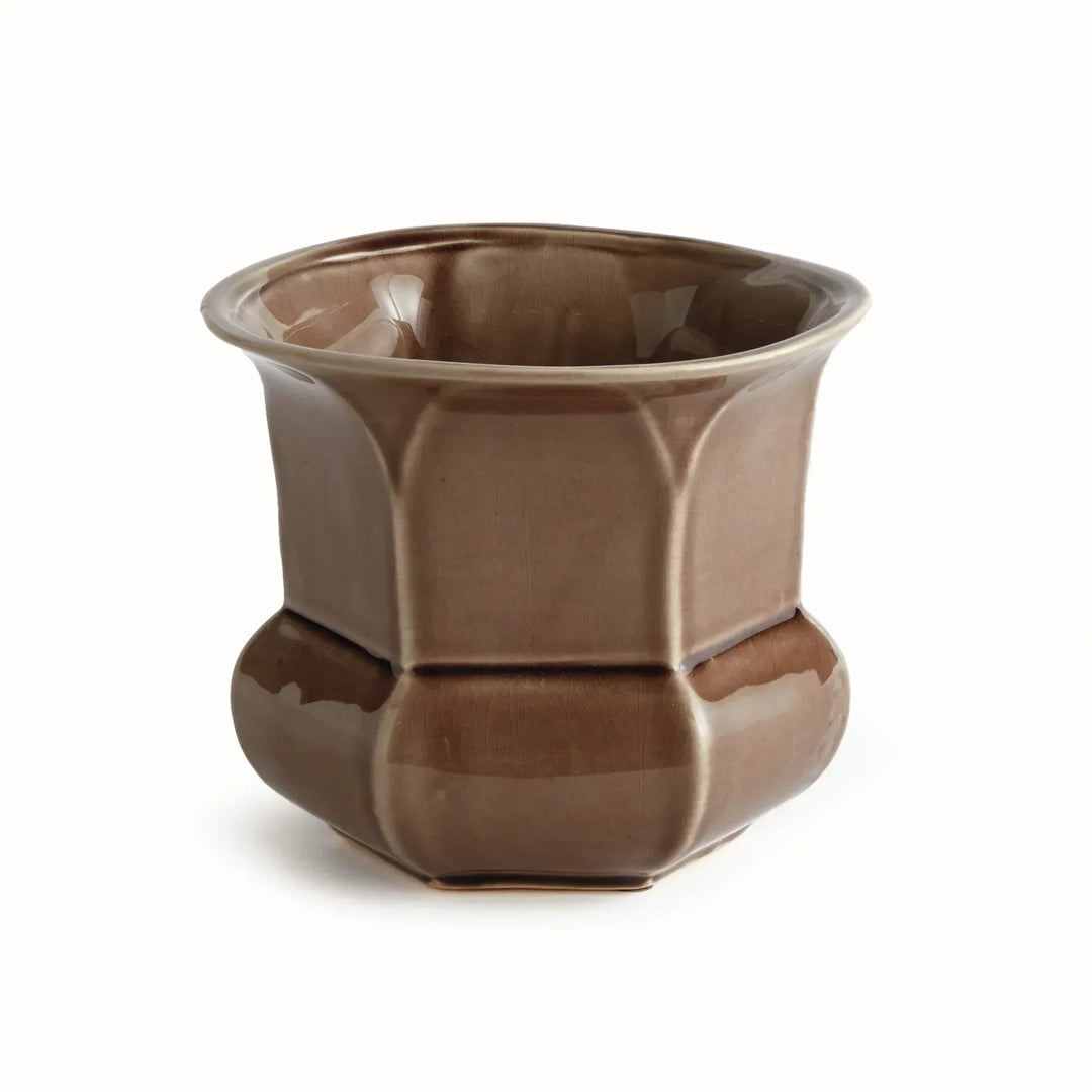 Brown reactive glaze ceramic planter with a flared rim, faceted sides and a rounded base, shown on plain white, Traditional