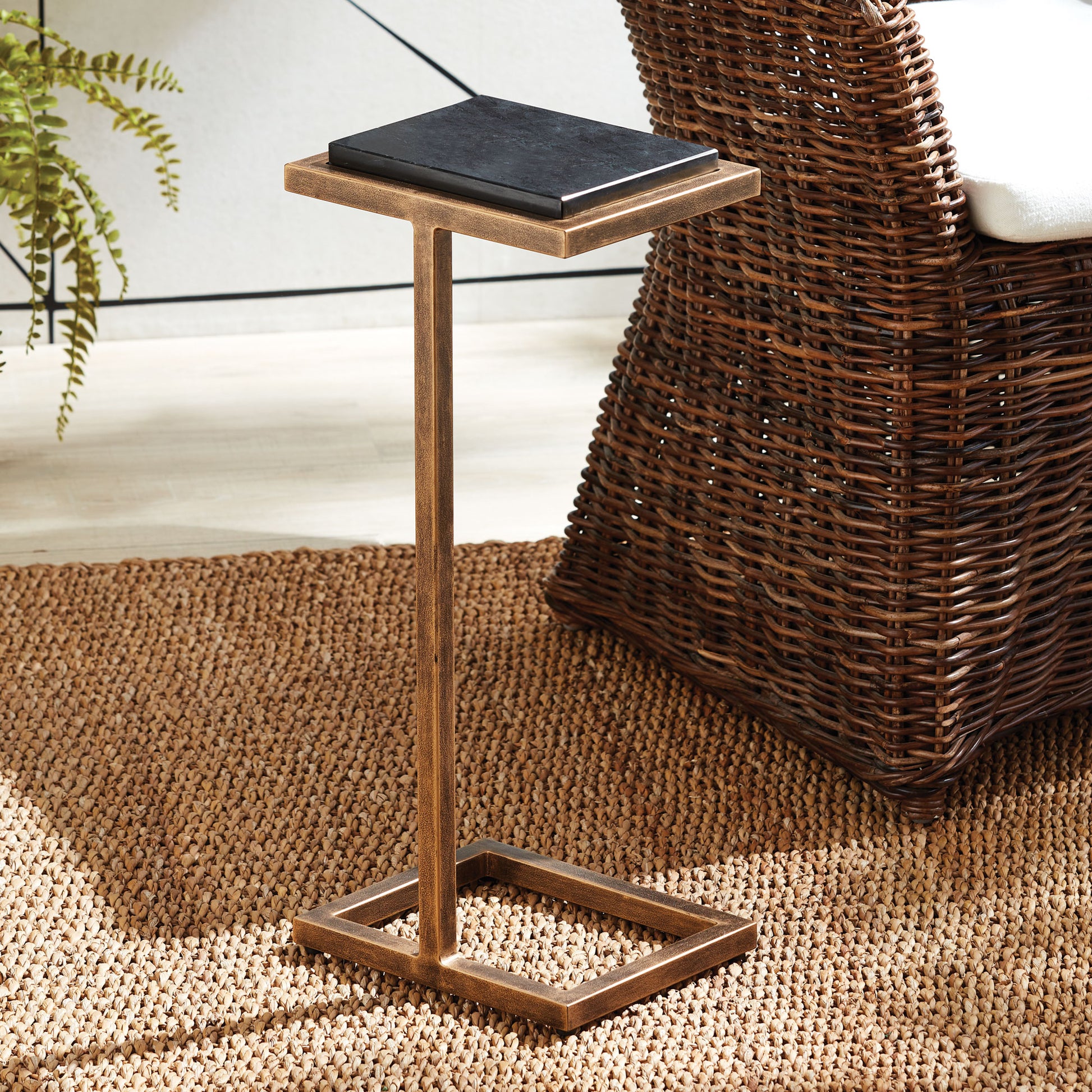 Expertly designed for modern living, this antique gold and black accent table exudes elegance with its petite surface and ornate frame. Effortlessly move it around your space to stylishly hold any beverage, dessert plate, or even a laptop. Its compact size adds versatility and convenience to any room.