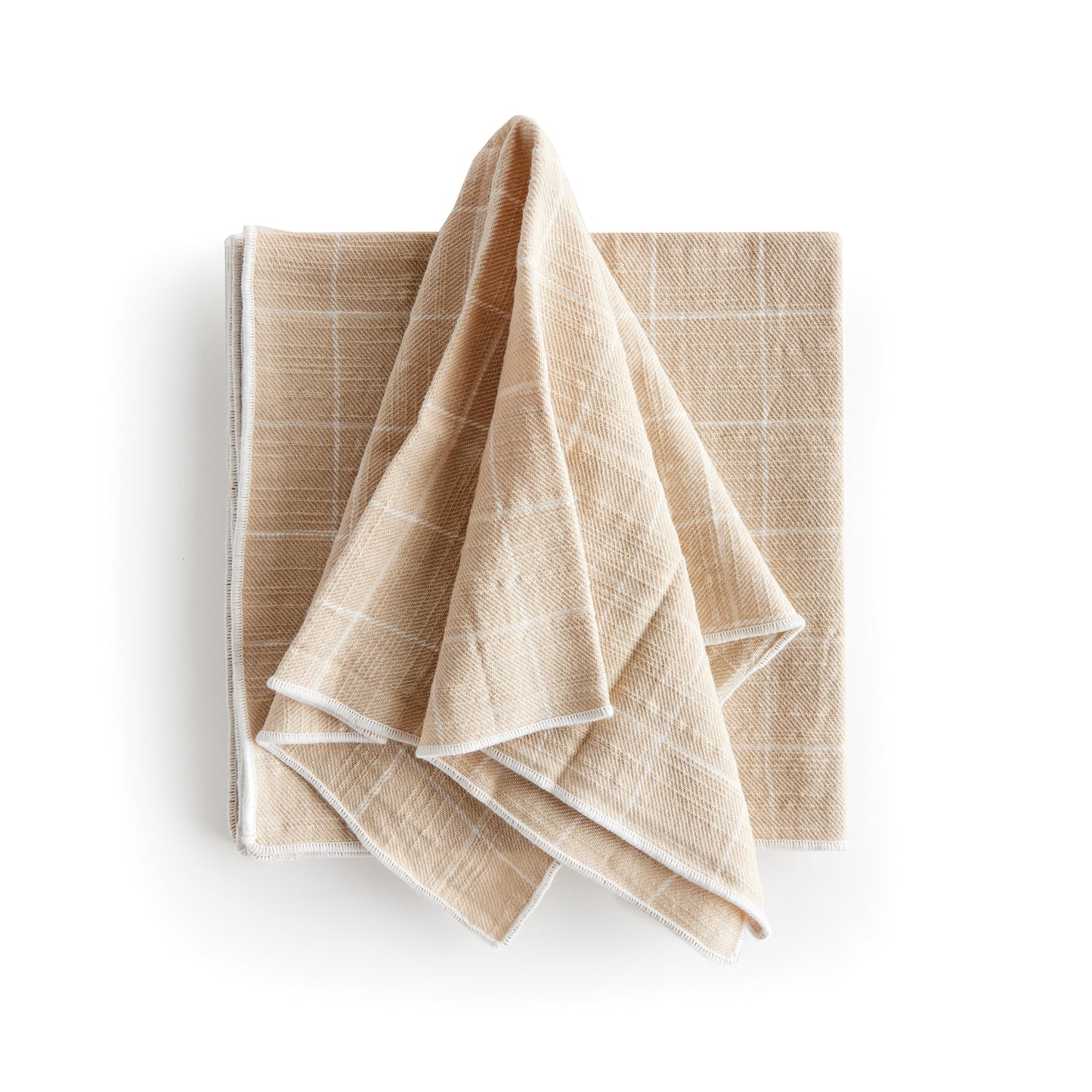 These four cotton napkins add a touch of softness to your table. The beautiful and textured soft taupe is designed to match any tablescape. Made of 100% cotton, they offer a luxurious and high-quality dining experience. The neutral taupe color seamlessly complements any table setting, enhancing both style and functionality for your meals.