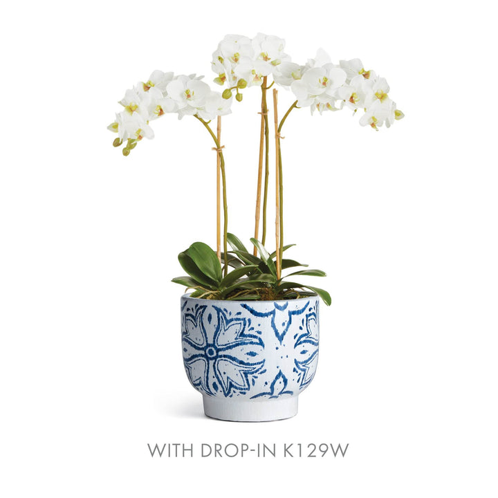 Blue and white ceramic cachepot planter shown with white orchid drop-in arrangement for styling reference – Coastal Casual.

