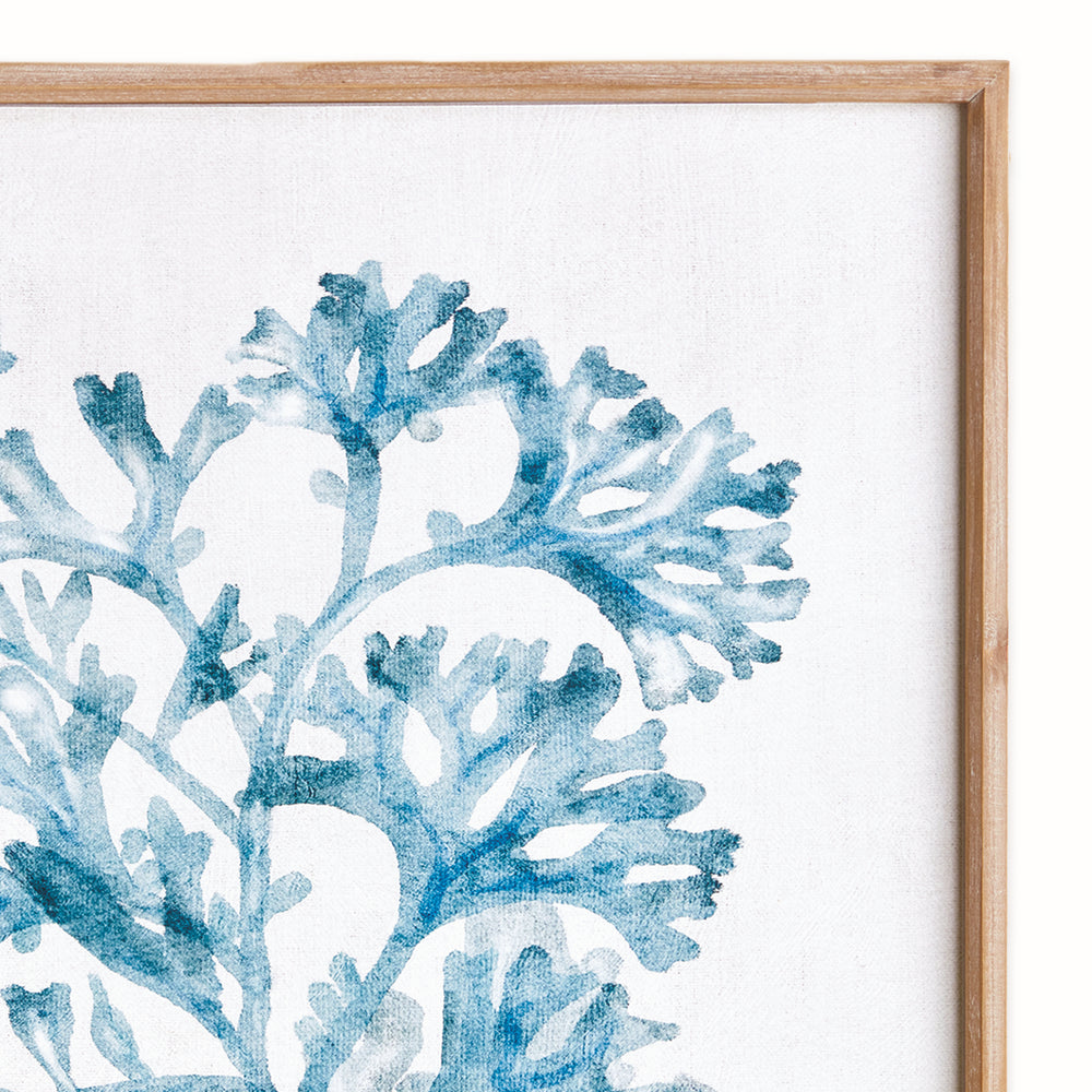 Close view of a blue coral print showing branching watercolor-style shapes on pale ground within natural wood frame. Coastal