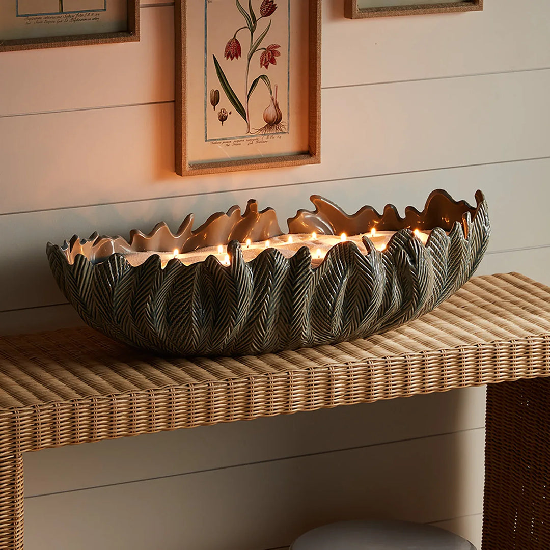 Candle sand used in large decorative vessel creating statement centerpiece with multiple flames and warm ambient glow