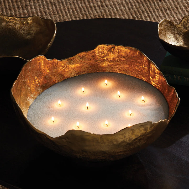 White candle sand in large decorative vessel with multiple wicks for warm ambient lighting, refillable candle sand kit in use