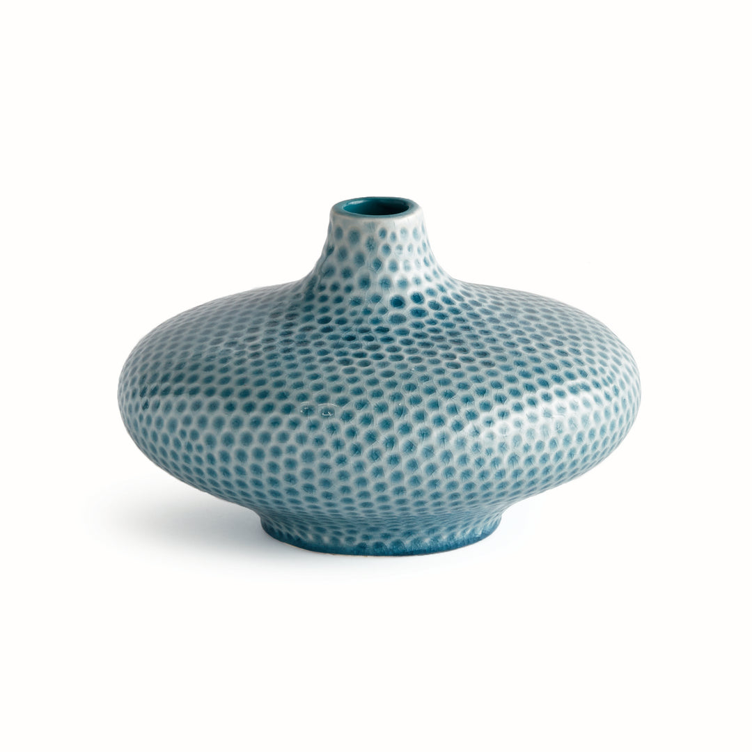 Carys low blue ceramic vase with a rounded body, raised narrow neck and dimpled reactive glaze on a white background. Coastal