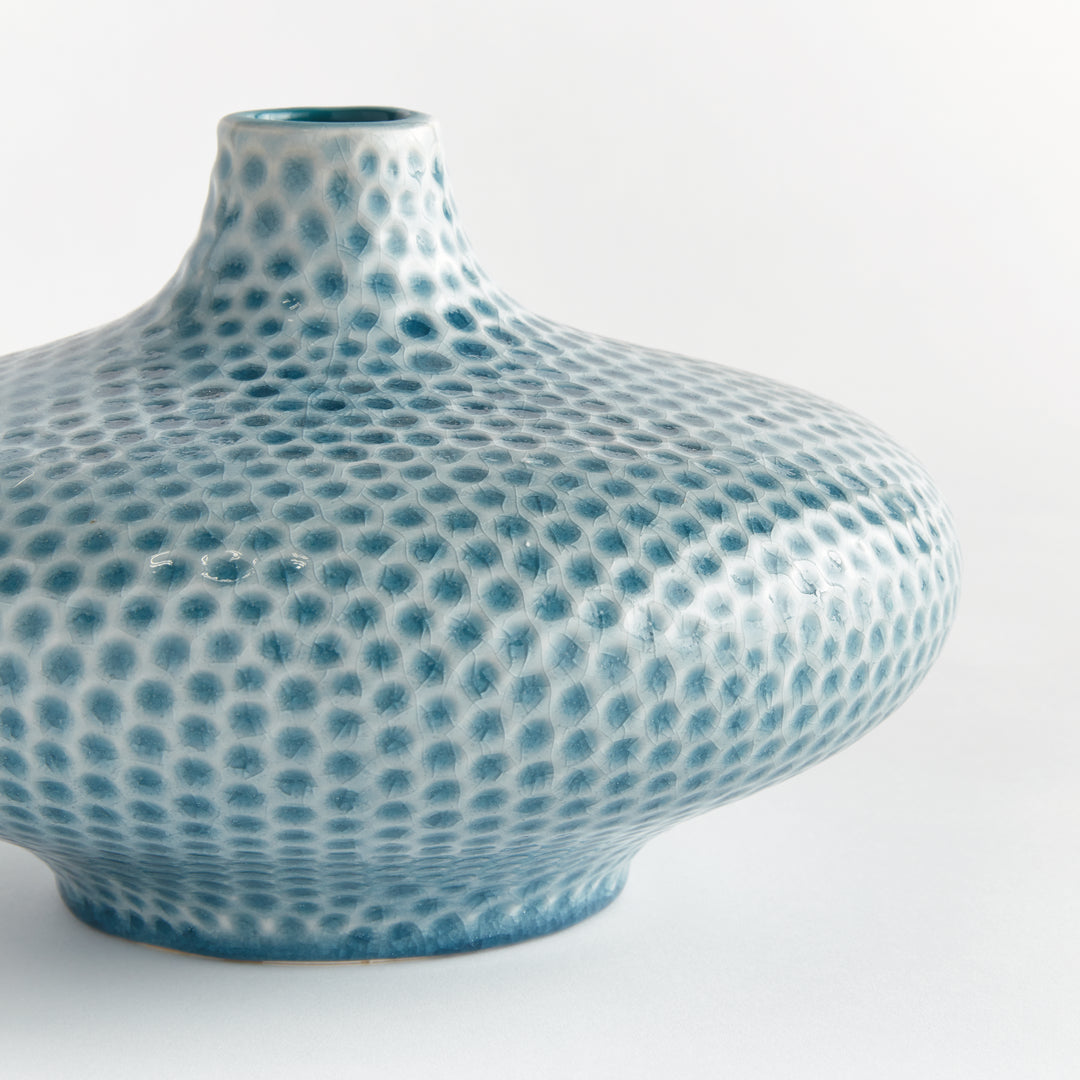 Close view of Carys low vase showing its narrow raised neck and blue dotted glaze across the curved ceramic shoulder. Coastal