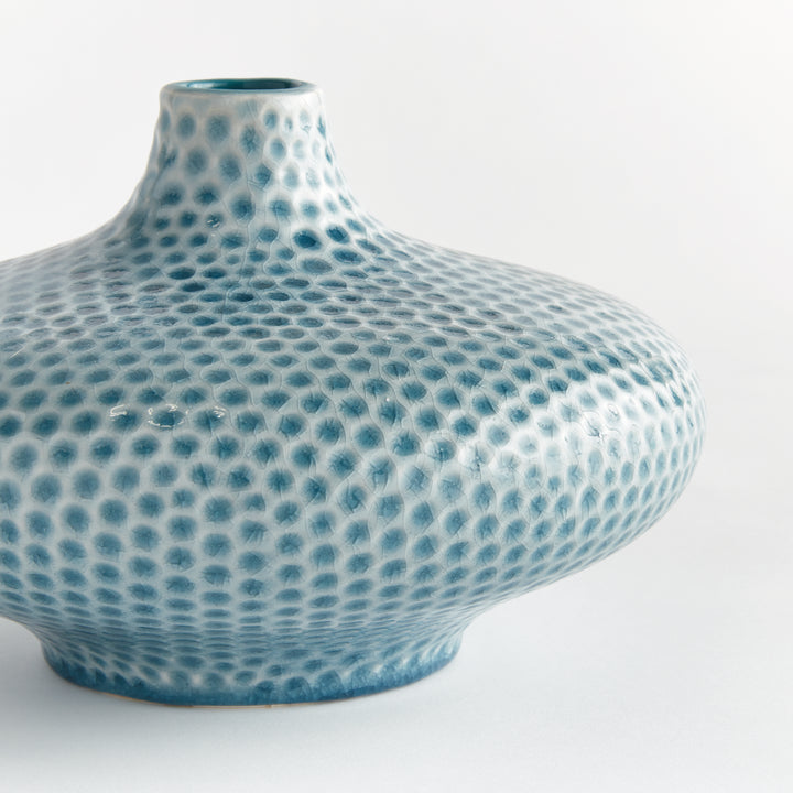 Close view of Carys low vase showing its narrow raised neck and blue dotted glaze across the curved ceramic shoulder. Coastal