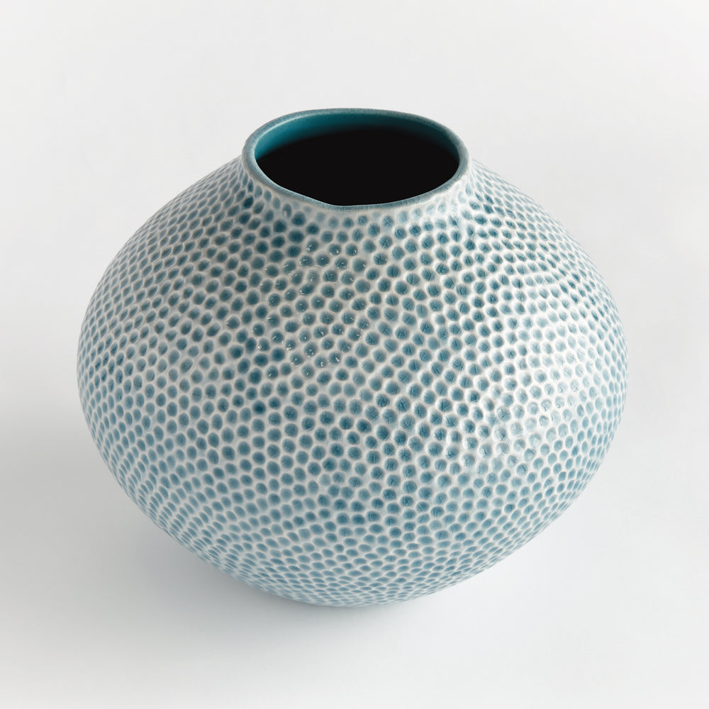 Angled view of Carys rounded blue ceramic vase showing its open neck, wide body and irregular glazed dotted texture. Coastal