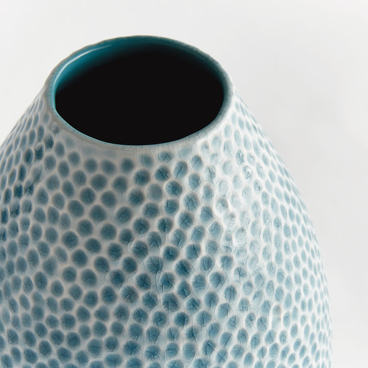 Close view of Carys tall vase neck with dark blue interior and textured blue reactive glaze around the open rim. Coastal