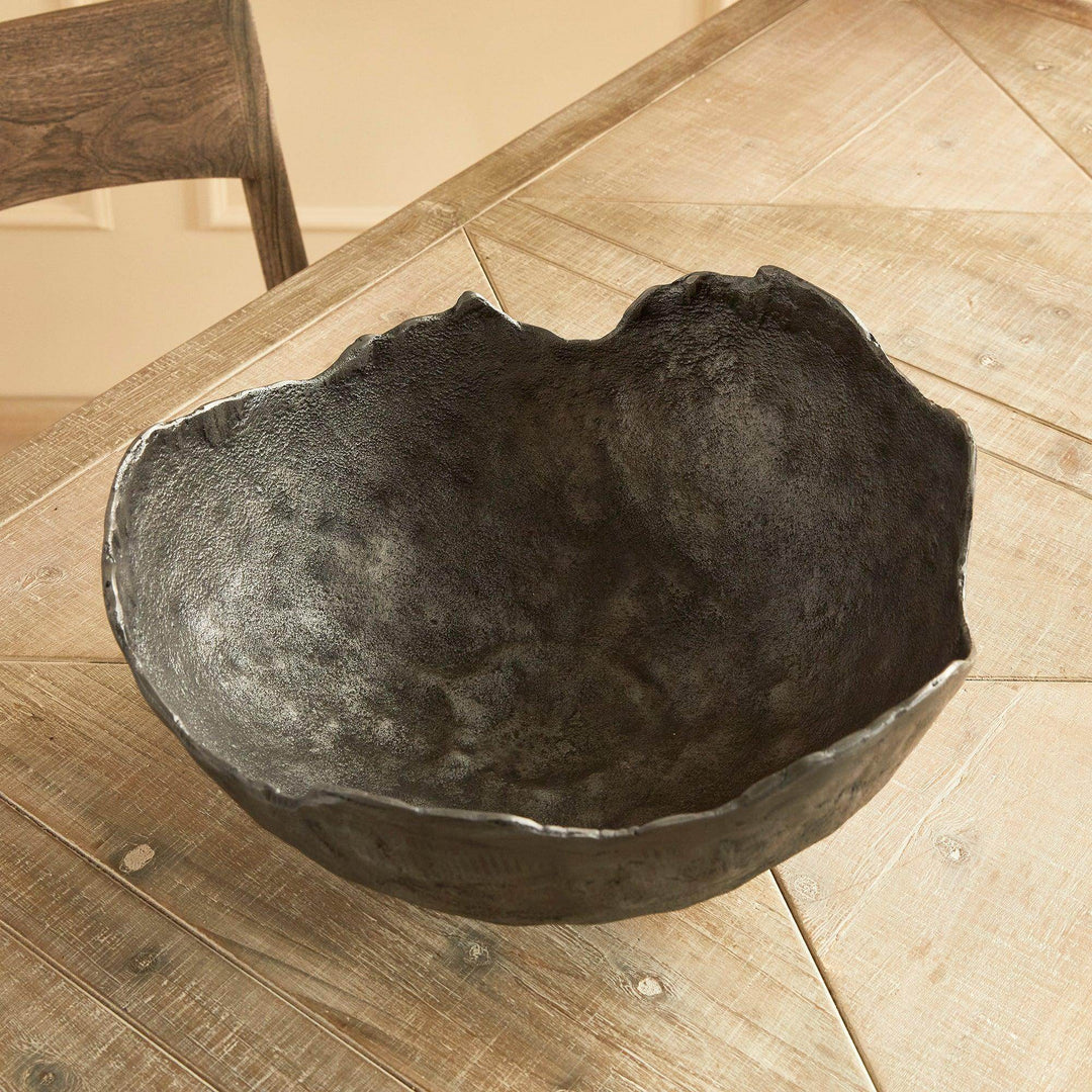 Black textured bowl on rustic wood table, styled in natural light as an Industrial Luxe dining table centerpiece