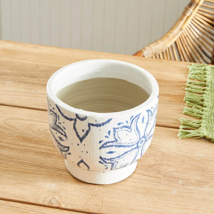 Blue and white ceramic cachepot planter shown overhead on wood table with soft interior finish and round opening – Coastal Casual.


