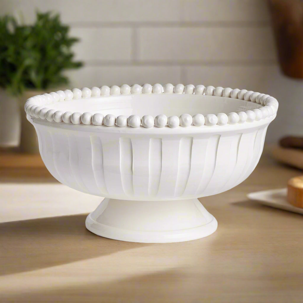 White ceramic coastal transitional bowl styled on wood surface with subtle shadows