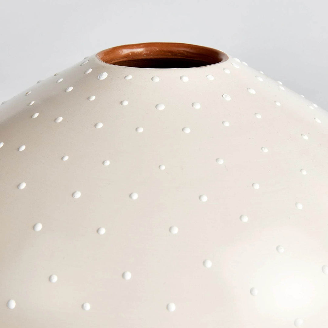Close-up of off-white ceramic surface and terracotta rim with raised stipple detail – Modern Organic

