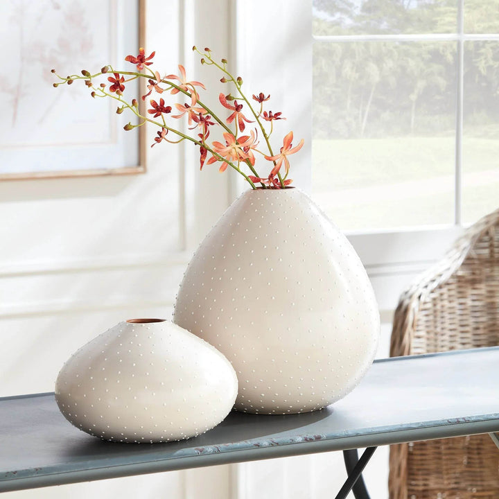 Large and small ceramic teardrop vases in off-white with stippling, styled on blue console table – Modern Organic

