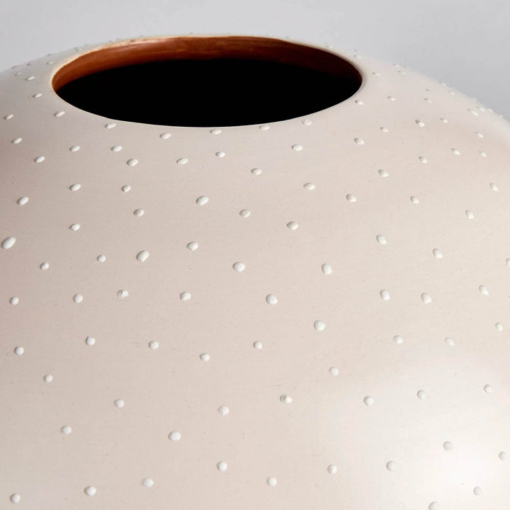 Matte off-white ceramic surface with hand-applied stipple detail and curved round silhouette – Modern Organic

