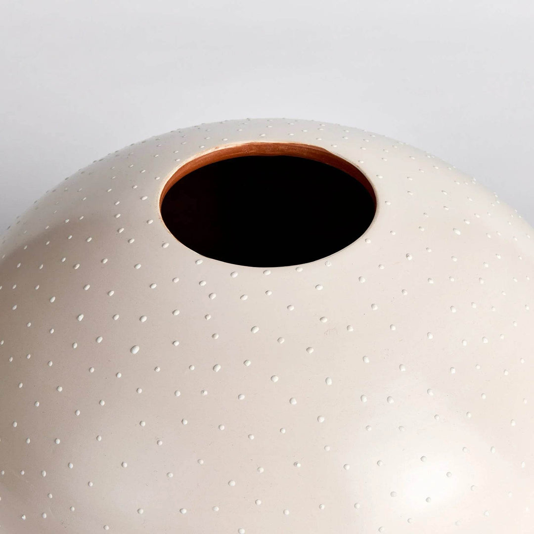 Close-up of stippled ceramic texture and rim on matte round artisan vase in neutral off-white – Modern Organic

