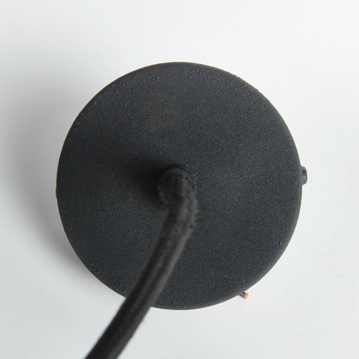 Overhead view of matte black pendant canopy and cord, designed for flush ceiling mount – modern organic style.