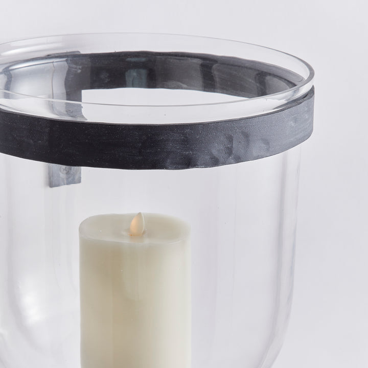 Close-up of clear glass wall candle holder showing aged zinc iron band, open rim and LED pillar candle in Modern Organic