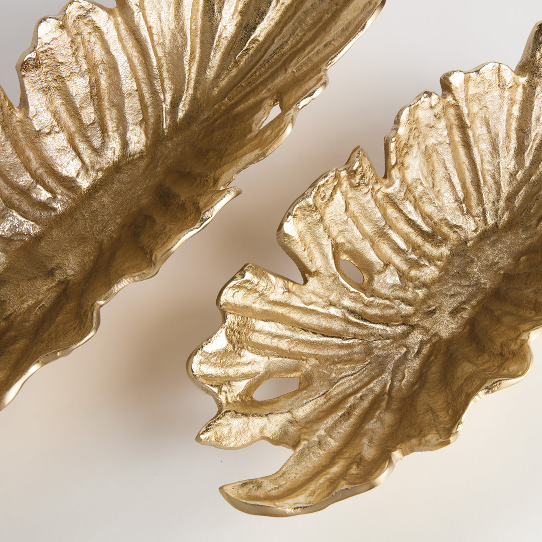 Close-up of textured ridge detail on gold cast aluminum decorative bowl with natural sculptural shape and metallic finish – Transitional style.