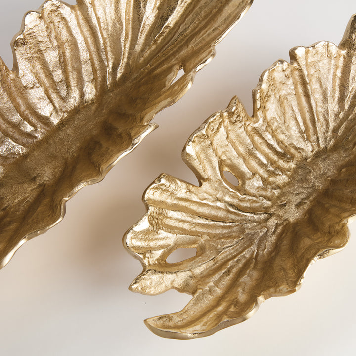 Close-up of textured ridge detail on gold cast aluminum decorative bowl with natural sculptural shape and metallic finish – Transitional style.