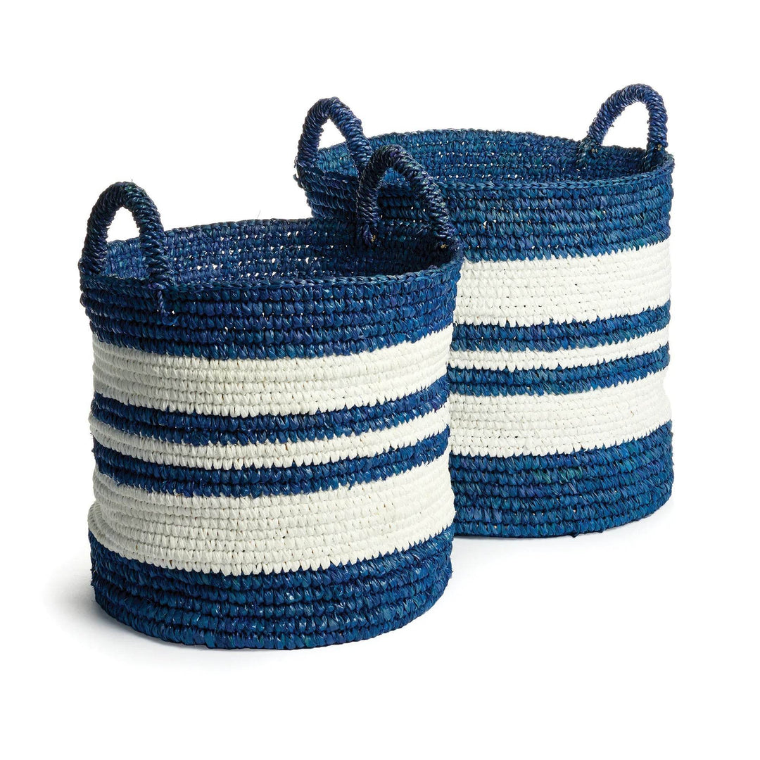 Set of two large decorative coastal baskets in blue and white seagrass, styled with handles for storage in beach-inspired interiors.


