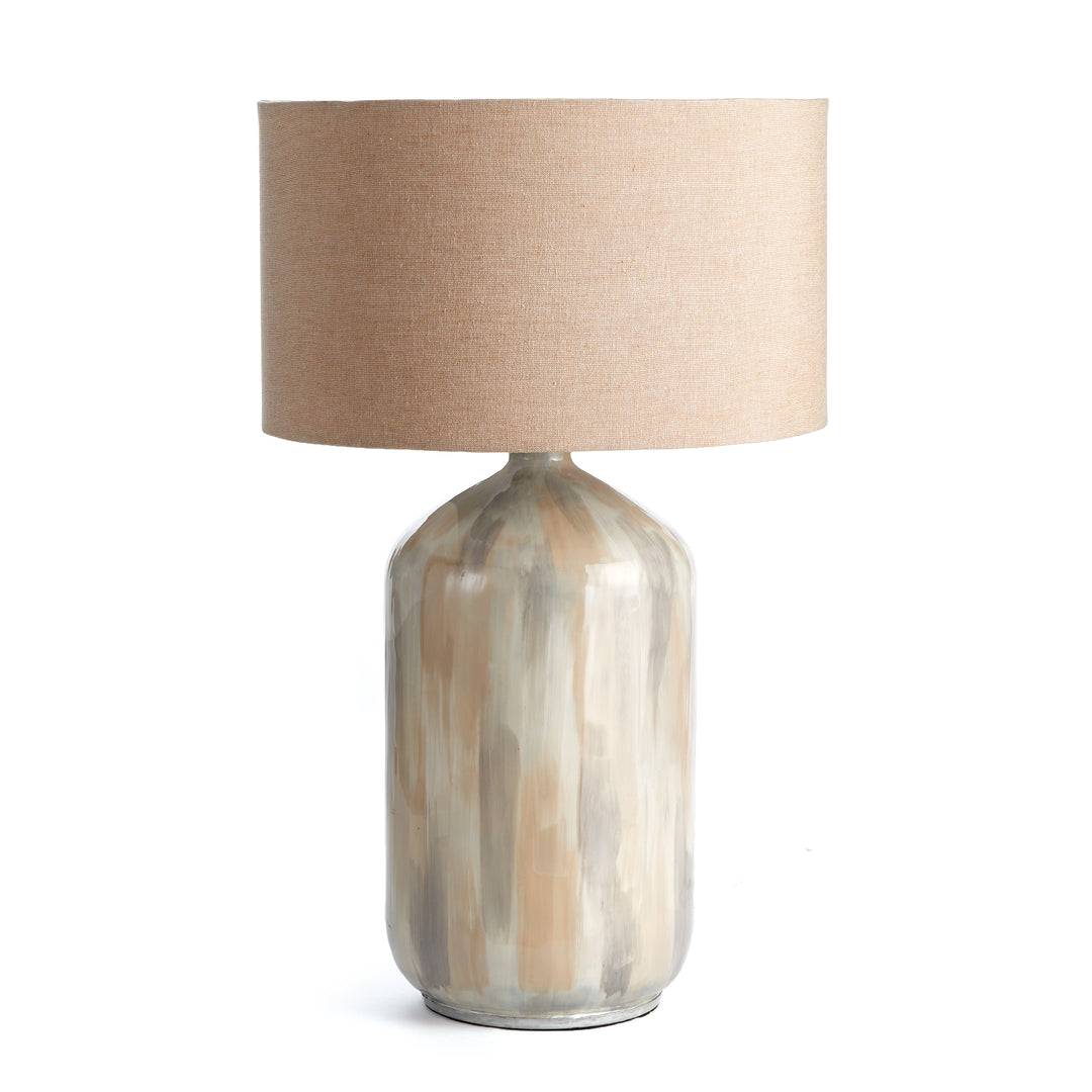 Handcrafted coastal table lamp with neutral cream tone-on-tone finish and oversized linen shade, shown on white background.

