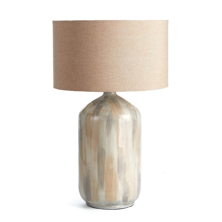 Handcrafted coastal table lamp with neutral cream tone-on-tone finish and oversized linen shade, shown on white background.

