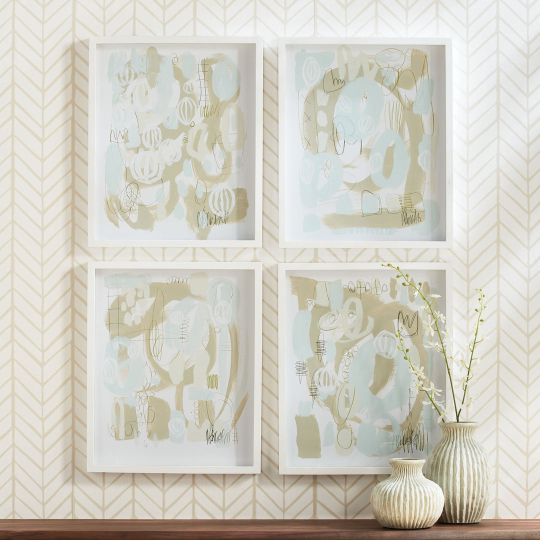 Framed blue and sage abstract wall art set of four with soft brushwork and white borders, styled with ceramic vases on console table.