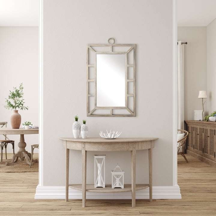 Rectangular wall mirror with whitewashed wood frame in a bright coastal transitional entryway