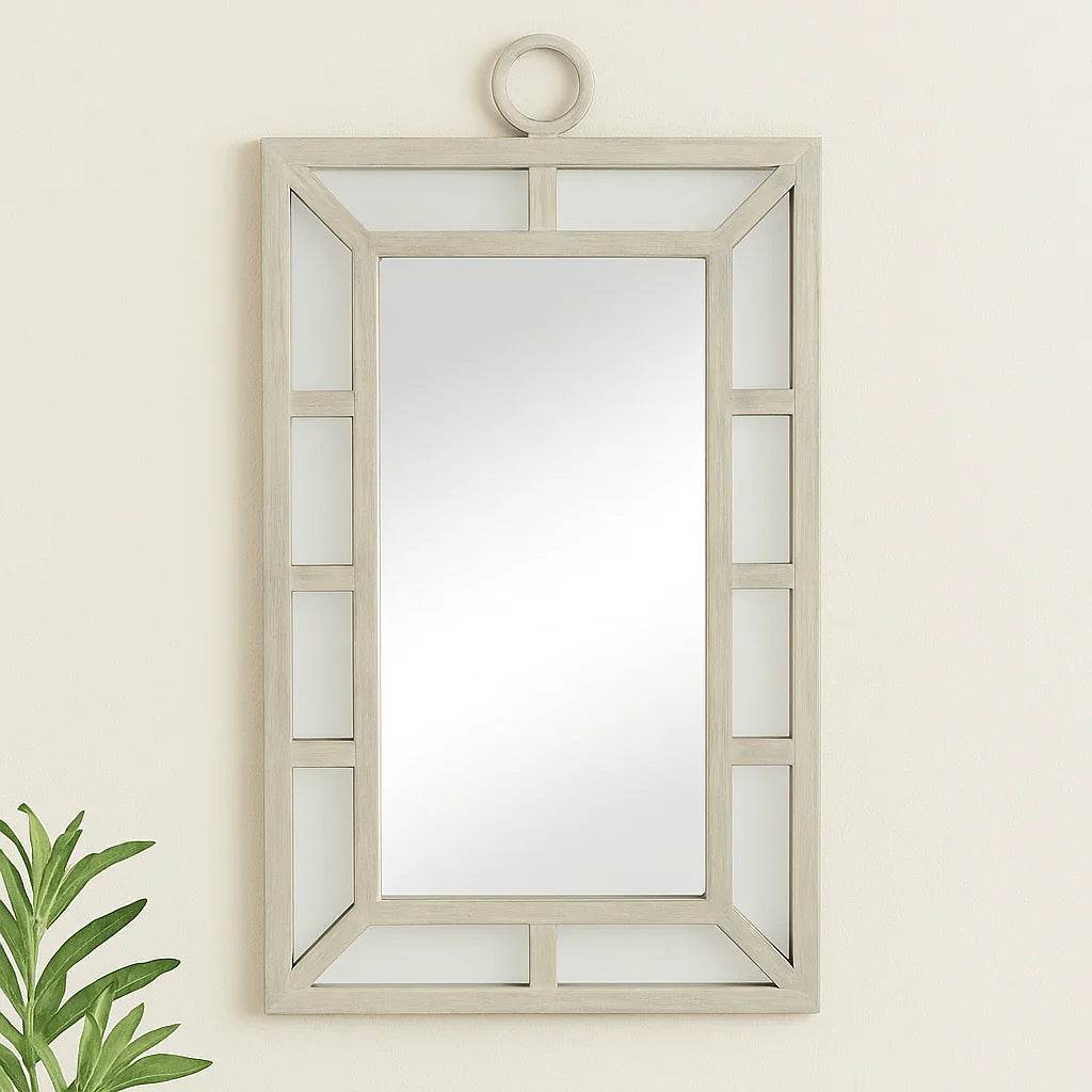 Coastal transitional rectangular wall mirror with whitewash finish styled in a neutral entryway setting

