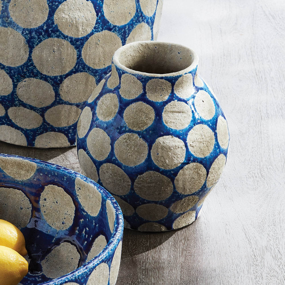 Cobalt ceramic vase with raised dots styled on tabletop with mid-century artwork and neutral accents – Mid-Century.

