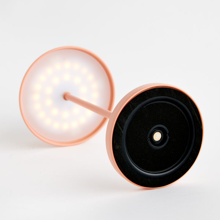Charging base detail for rechargeable cordless LED table lamp showing magnetic charging connection and underside construction – Contemporary