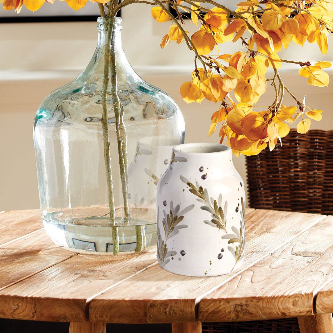 Cream painted terra cotta vase with hand-painted olive branch detail and rounded form, shown styled on a wood surface – Modern Farmhouse

