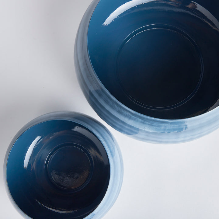 Featuring a delicate swirl pattern inspired by coastal hues of blue and gray, these Andrey Decorative Bowls are a stunning set of two crafted from enameled iron. Each bowl is hand-painted with precise, lightweight strokes, using a sophisticated horizontal design. The modern artistry and portable elegance make this set a unique addition to your tableware.