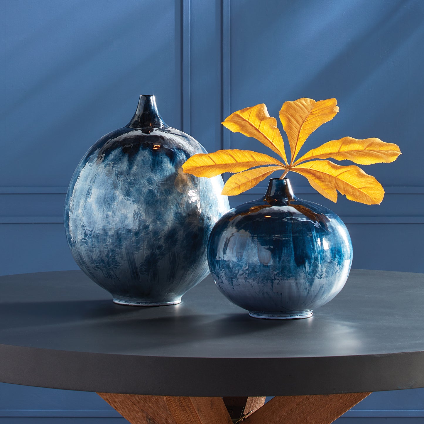 Expertly crafted and elegantly designed, Neptune Blue Vase Short features durable, lightweight enameled iron construction. Hand-painted with a color palette inspired by nature, this vase is a stunning display of art and natural beauty. Upgrade your home decor with this impressive piece.