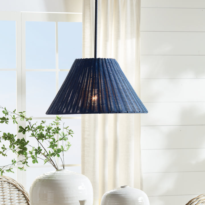 Dark blue rattan pendant light with tapered woven shade hanging in bright interior space with soft ambient glow – Coastal