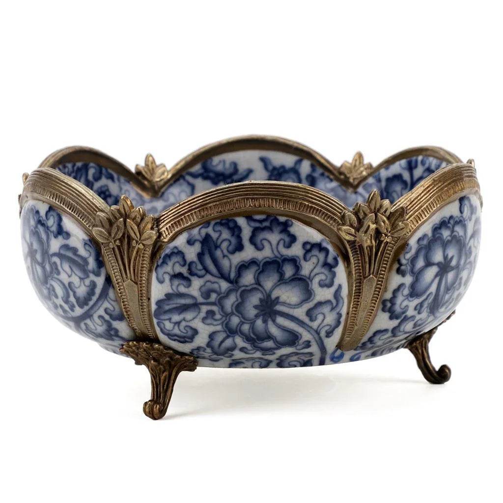 Decorative porcelain bowl with bronze mounts shown angled on display surface – Transitional