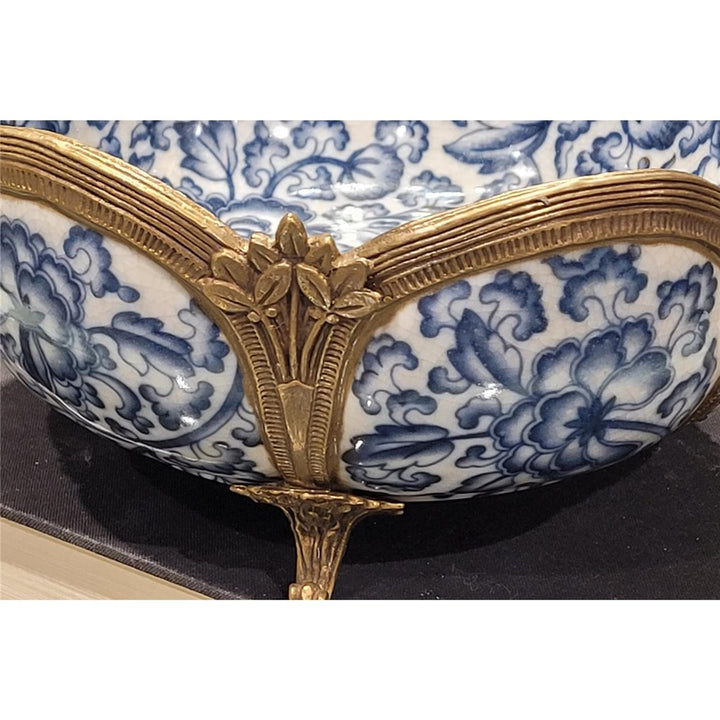 Close-up detail of porcelain floral bowl with bronze ormolu frame and feet – Transitional