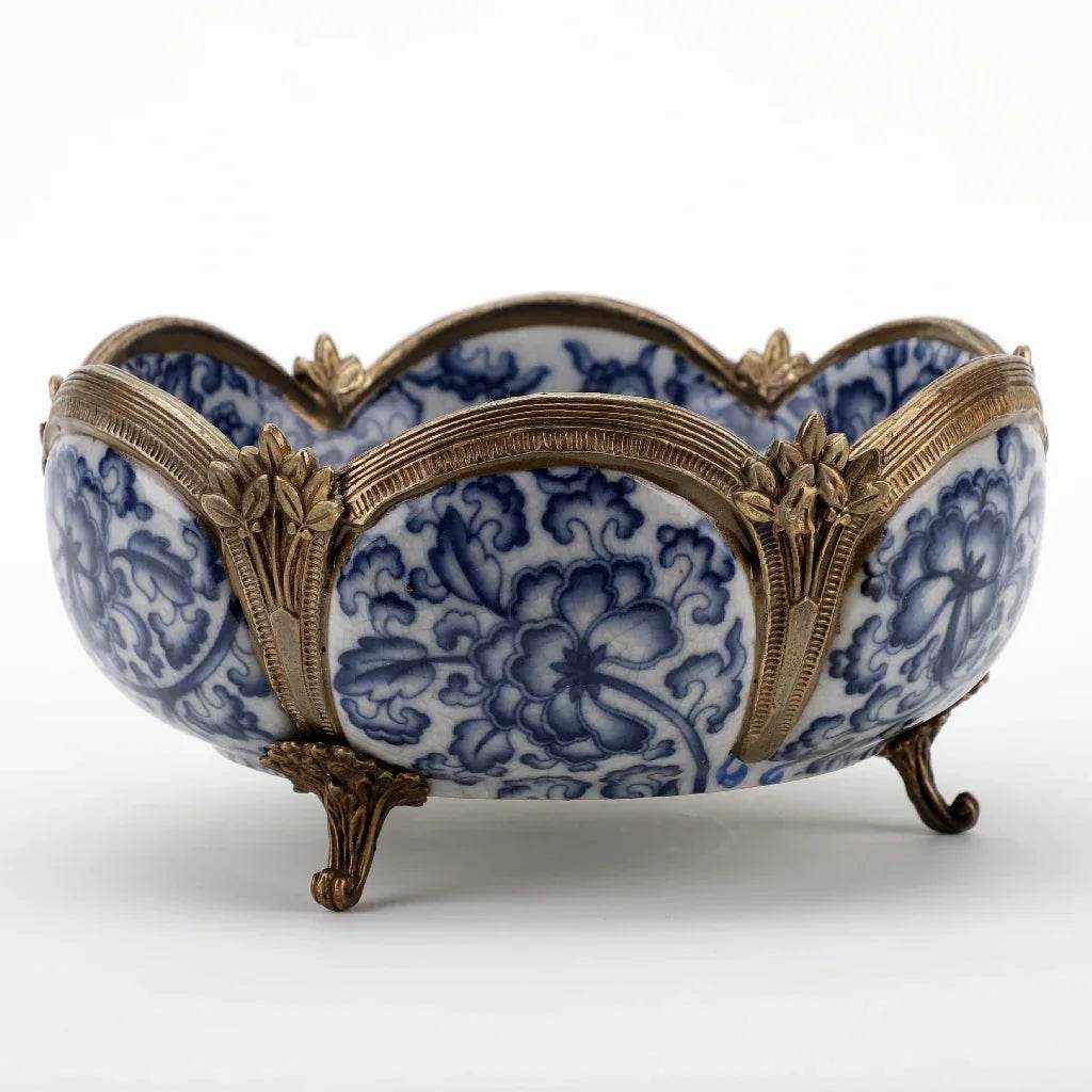 Blue and white porcelain floral bowl with bronze accents shown from front view – Transitional