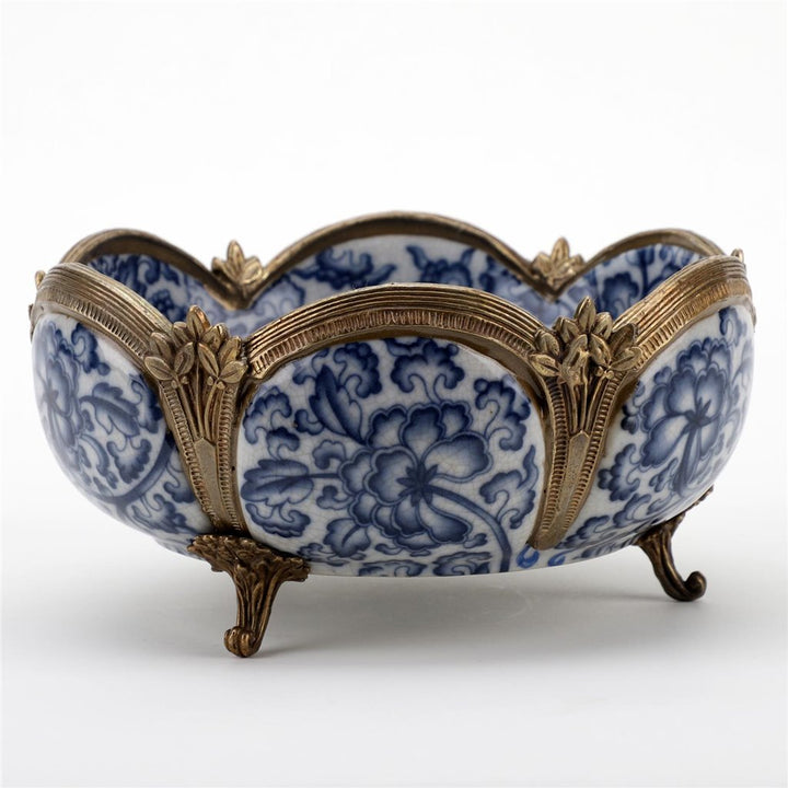 Decorative porcelain bowl with bronze mounts styled in a home décor display – Transitional