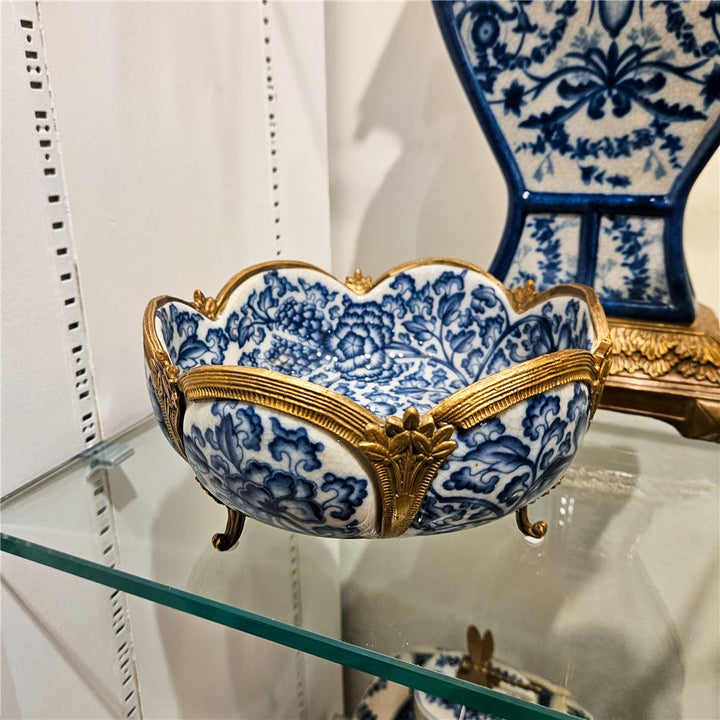 Side profile of porcelain decorative bowl with blue floral design and bronze accents – Transitional