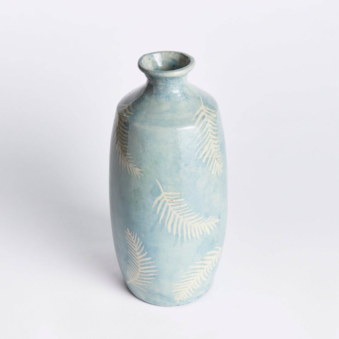 Rear angle of blue decorative vase showing rounded silhouette and botanical pattern