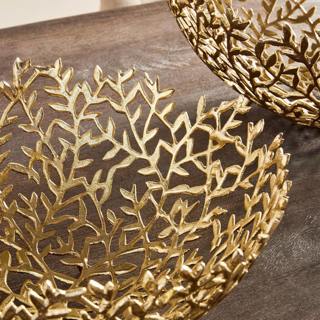 Close-up of gold vine detailing on the decorative bowl showing dimensional texture and handcrafted finish.