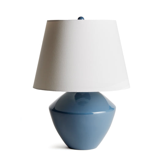 This handsome lamp has a classic silhouette. The body was crated from a centuries old wooden mold. We brought it back to life in a deep blue finish. Topped with a tapered fabric shade, it makes a dynamic, storied lamp for family room, study or bedroom.