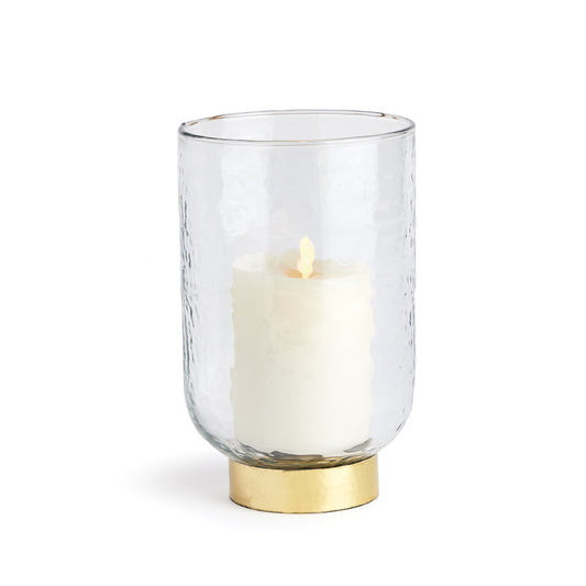 Made of a thick, hammered glass and featuring a melted uneven edge this hurricane  has an artisan's touch. Finished off with a hammered gold rim Base, an elegant accent for console, bookshelf or mantel.